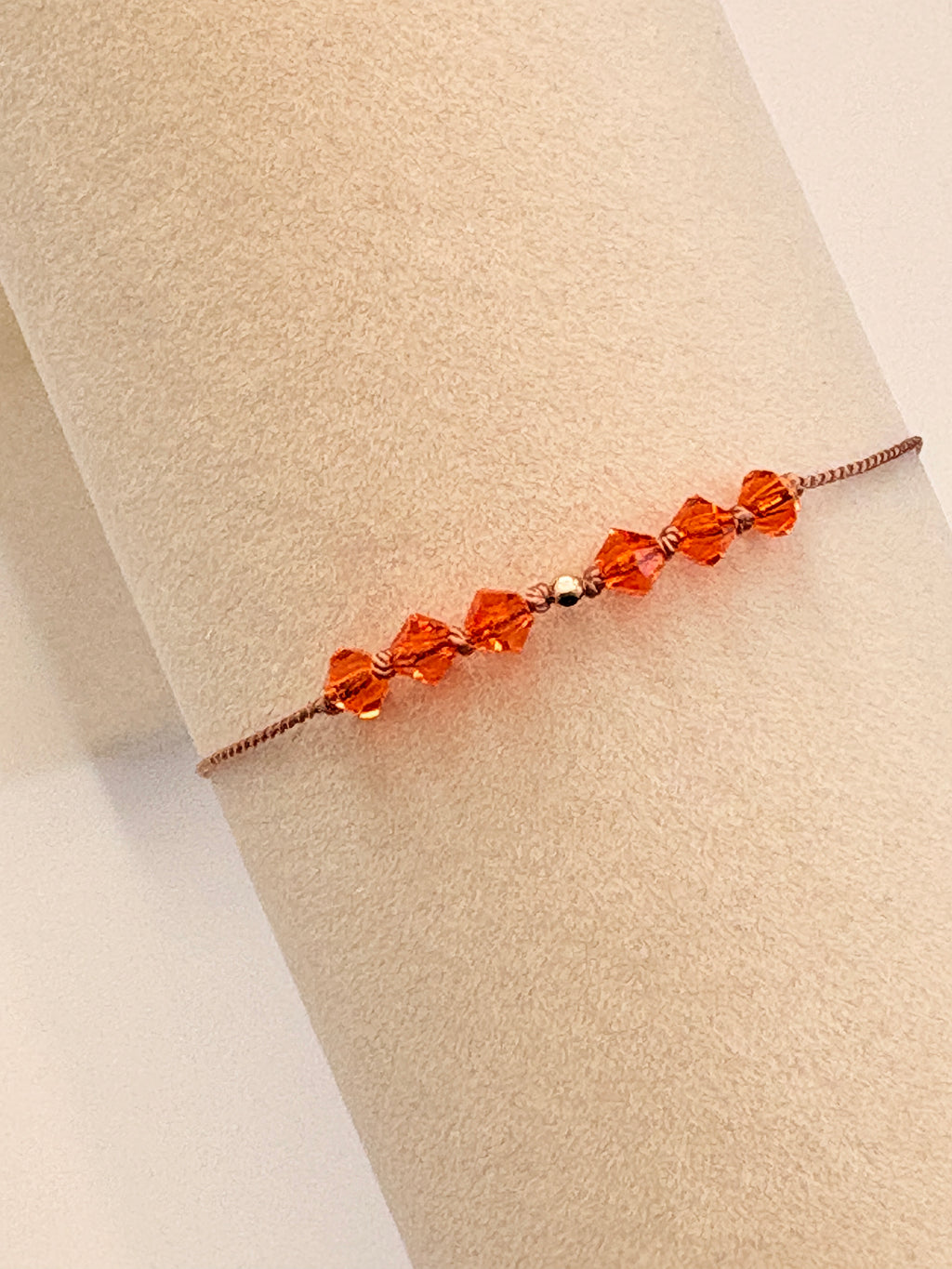 Radiant Hope bracelet displayed on a beige cream T-stand, showing Sun crystals and gold-filled details.